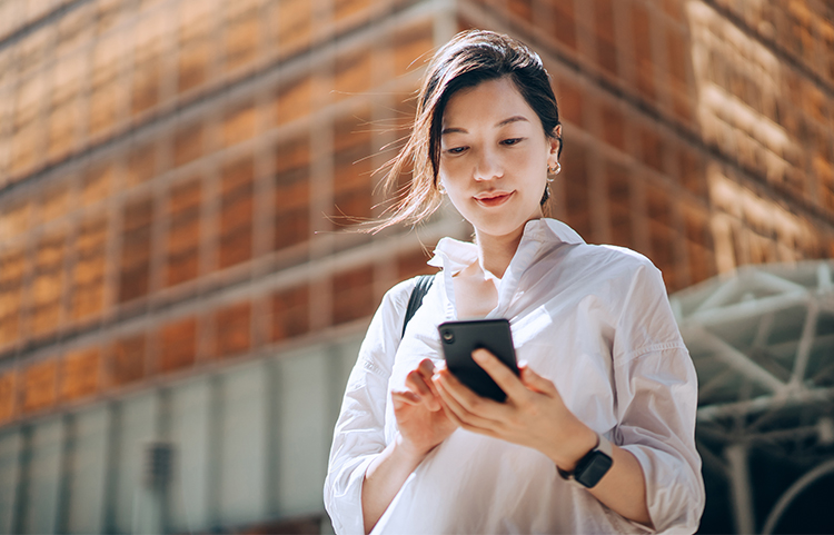 A woman looking down at her phone