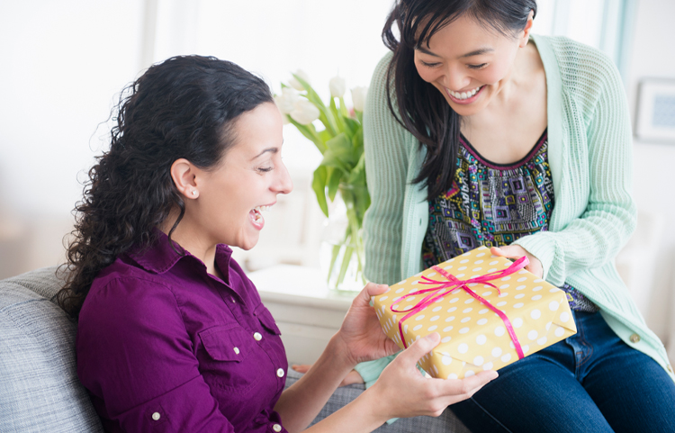 Two women exchanging gifts